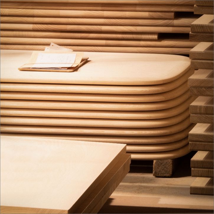 An image showing a stack of ercol table tops ready to be constructed
